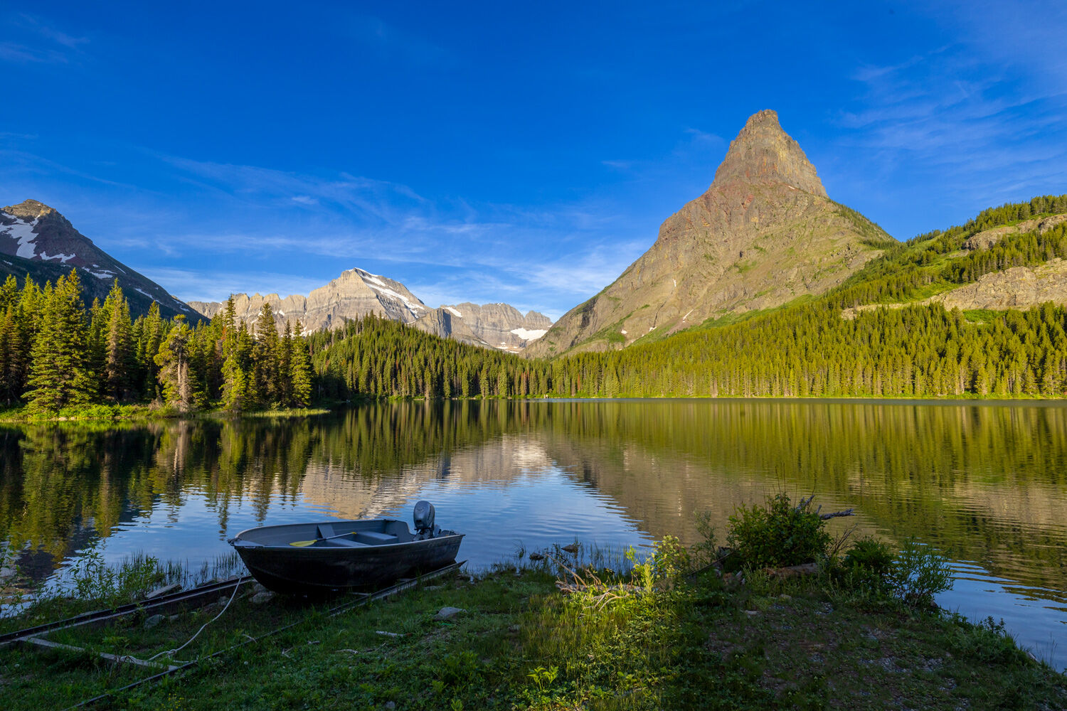A boat provides a tempting way to explore the beauty of Swiftcurrent Lake.