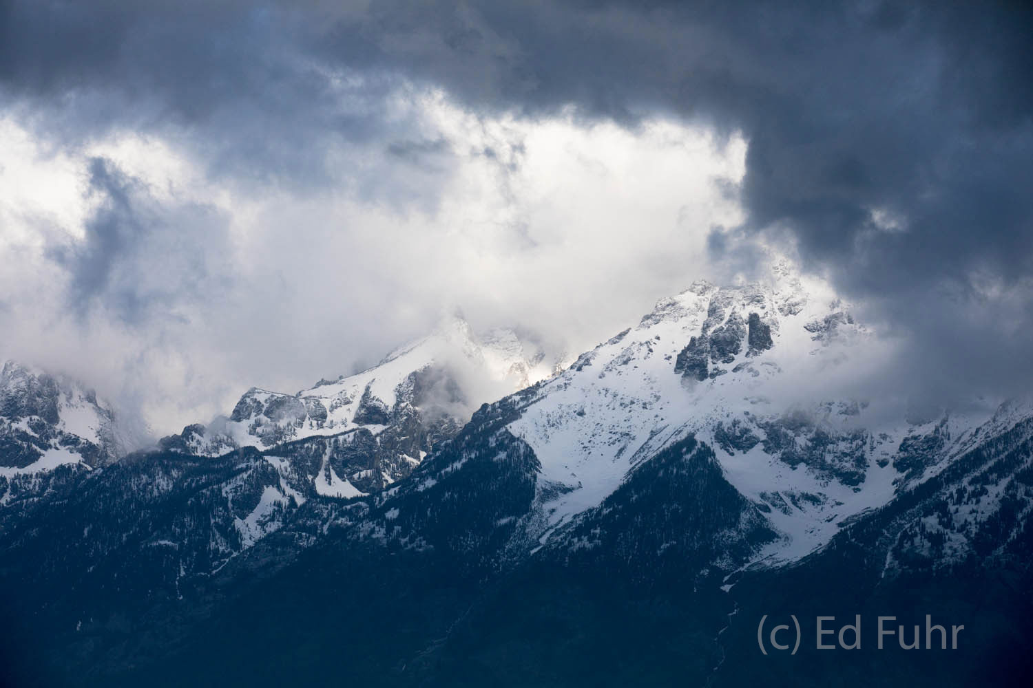 A storm struggles to pass by the Teton range.