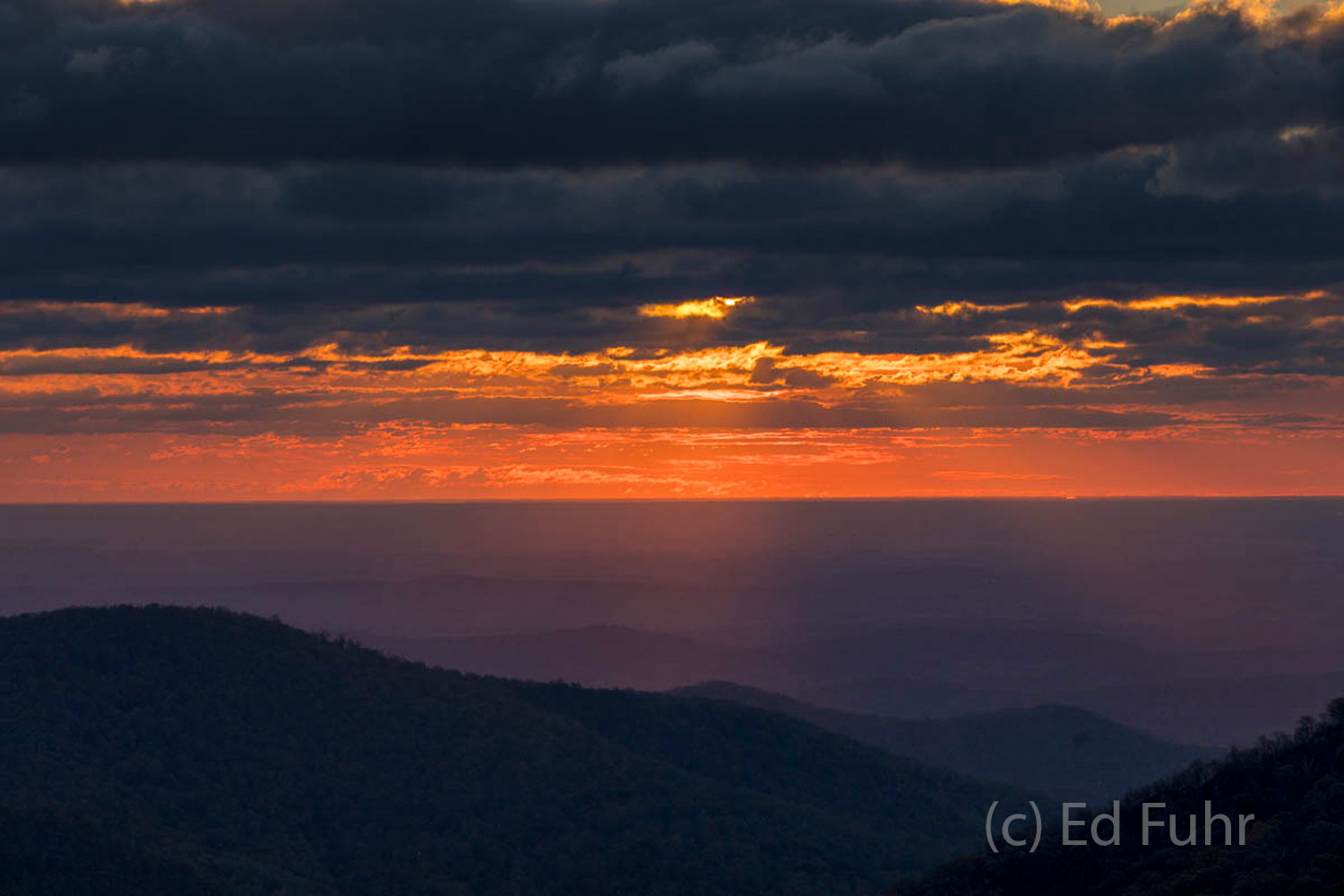 The Sun rises over the Piedmont, soon to disappear behind a bank of storm clouds.