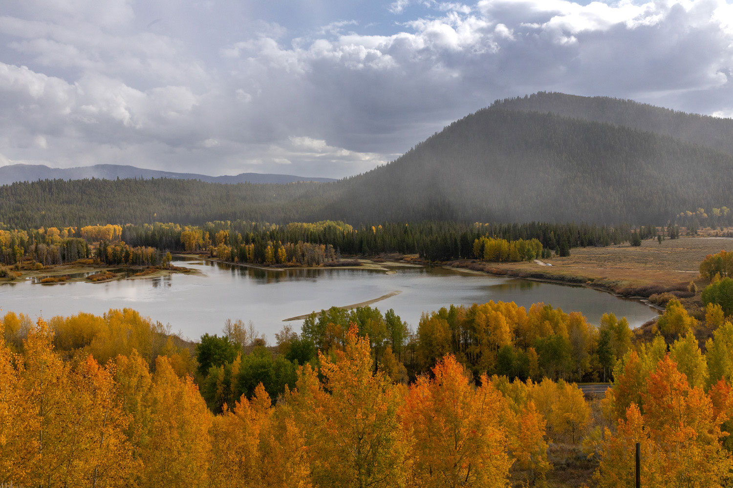 A climb up a steep nearby ridge affords a stunning view of the changing aspen around Oxbow Bend, as the snow begins to fall in...