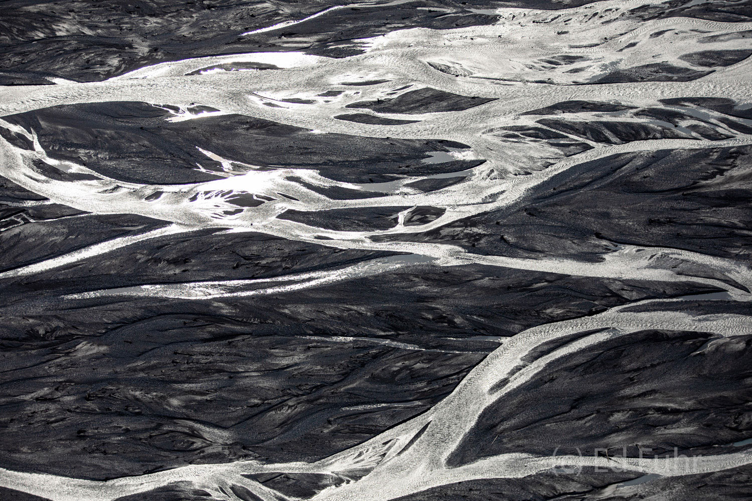Glistening Denali's riverways glisten below