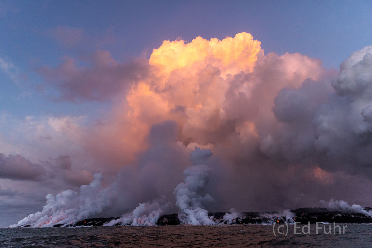 A giant plume of steam rises above one of the points of entry into the sea.