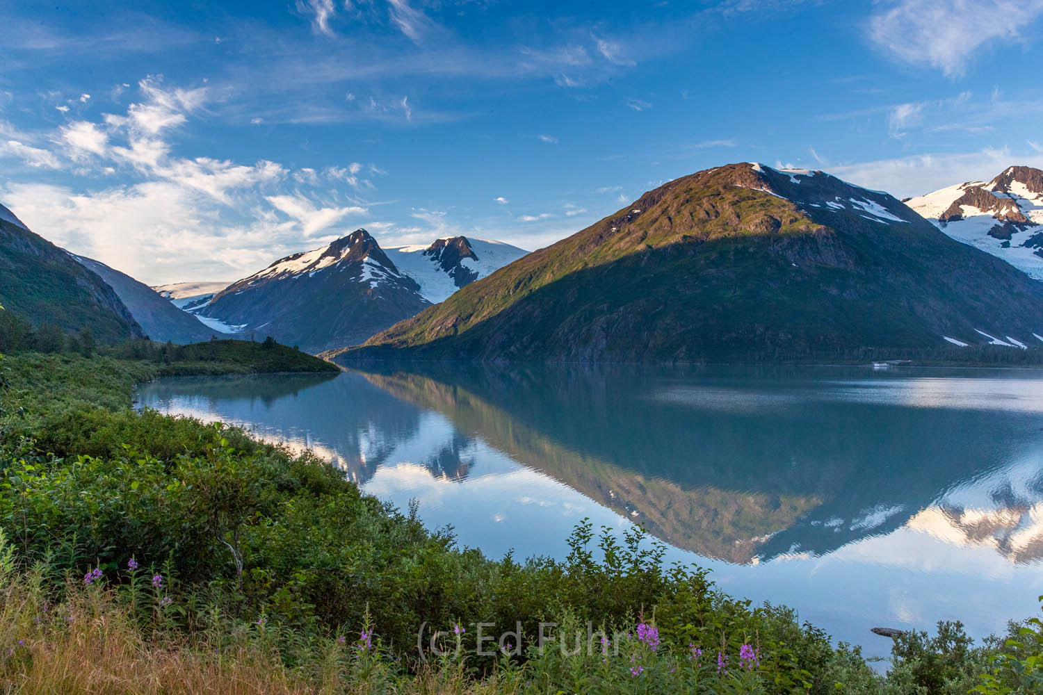 Retreating Portage Glacier can be seen in the left as sunrise hits the peaks across Portage Lake.