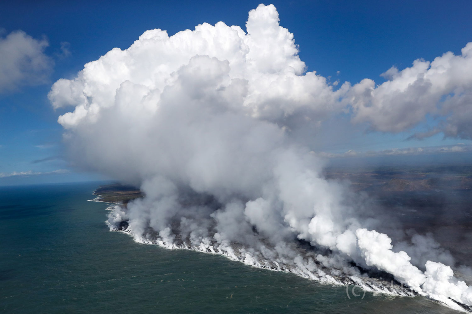 Steam rises above miles of the east coast of the Big Island