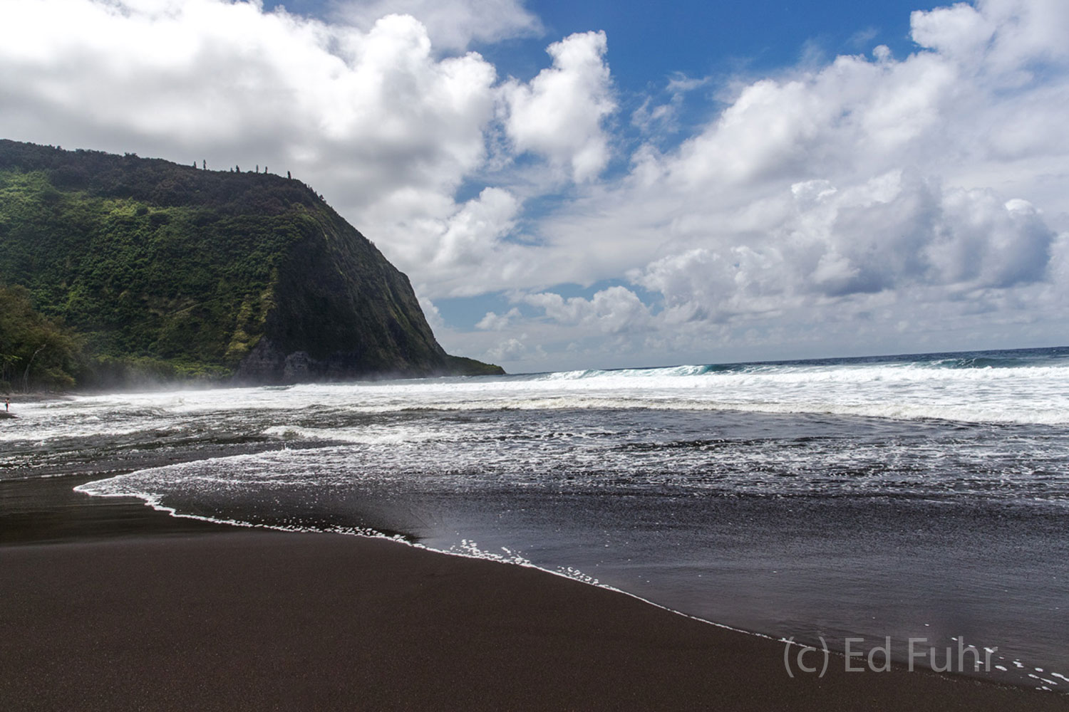 The lush Waipio Valley is guarded by an equally beautiful black sand beach that can be reached only by a very steep one mile...
