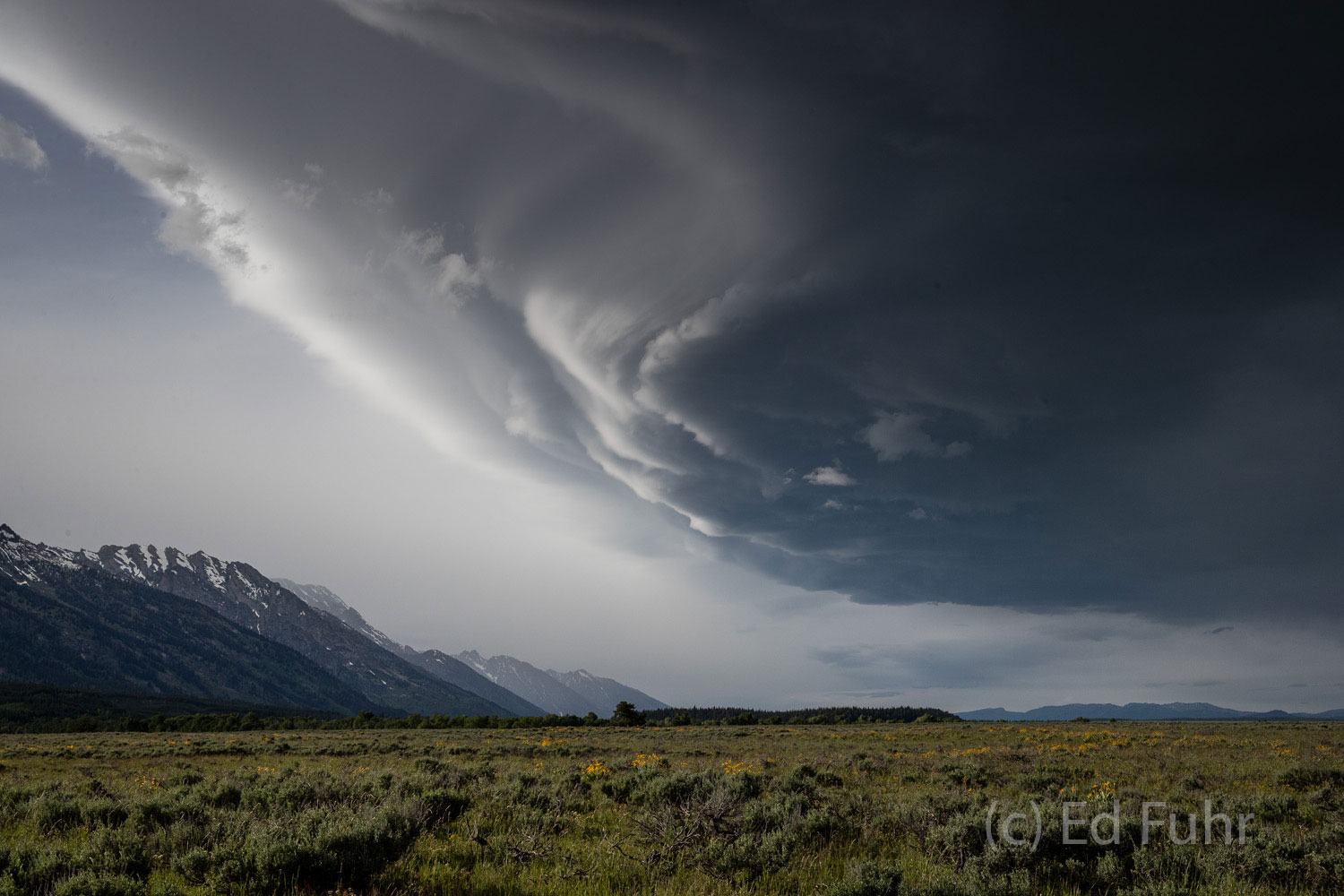 A powerful thunderstorm cell sweeps over the Teton range and across the valley floor.