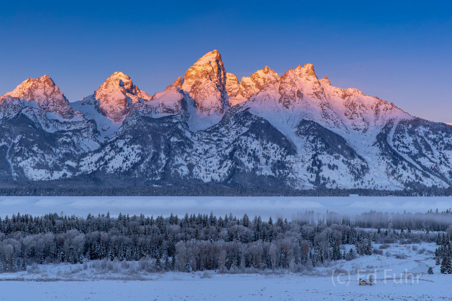 In a matter of just a few minutes, the rising sun has elevated enough to light half the Teton range.