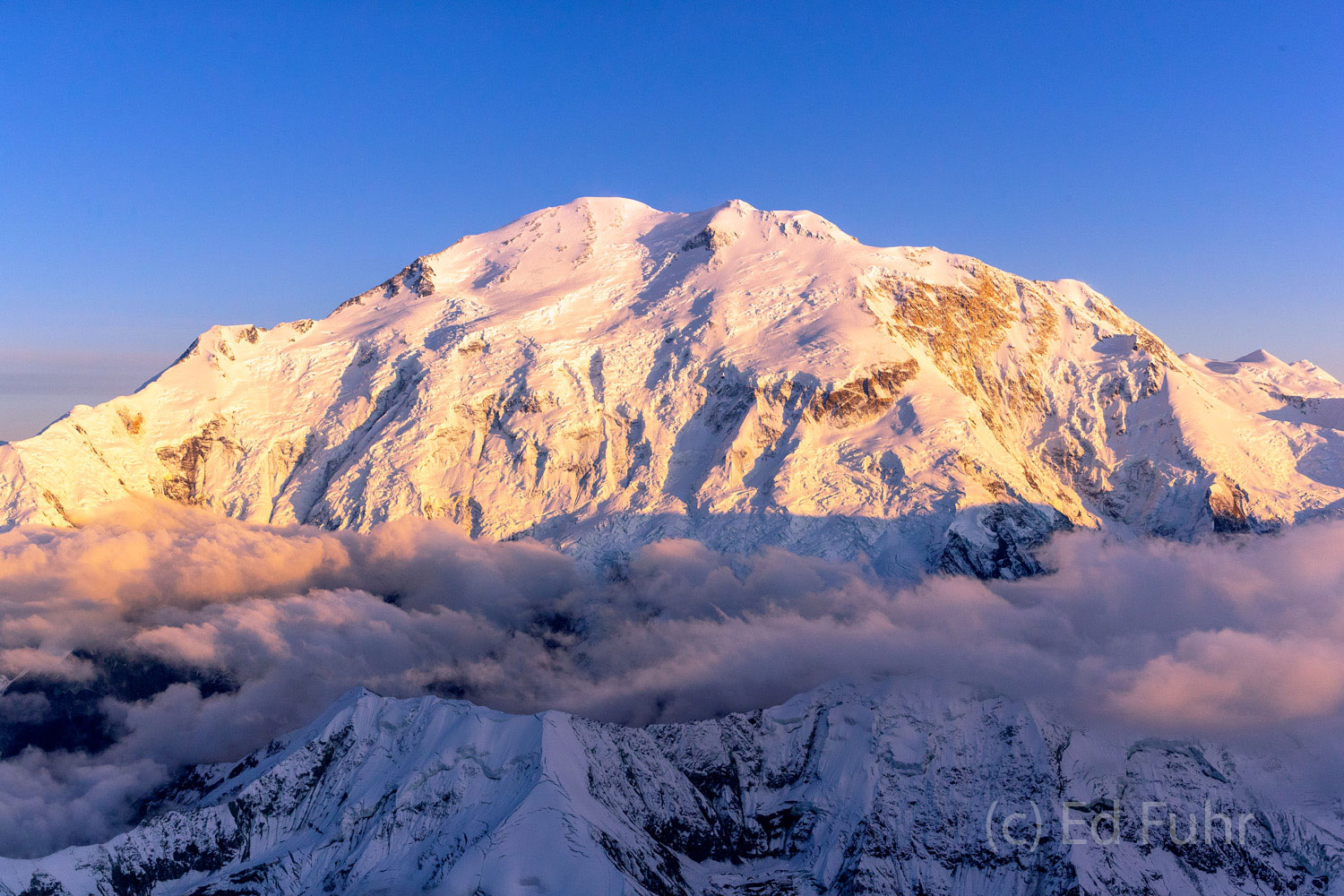As the sun rapidly descends to the horizon, Denali glow turns golden.