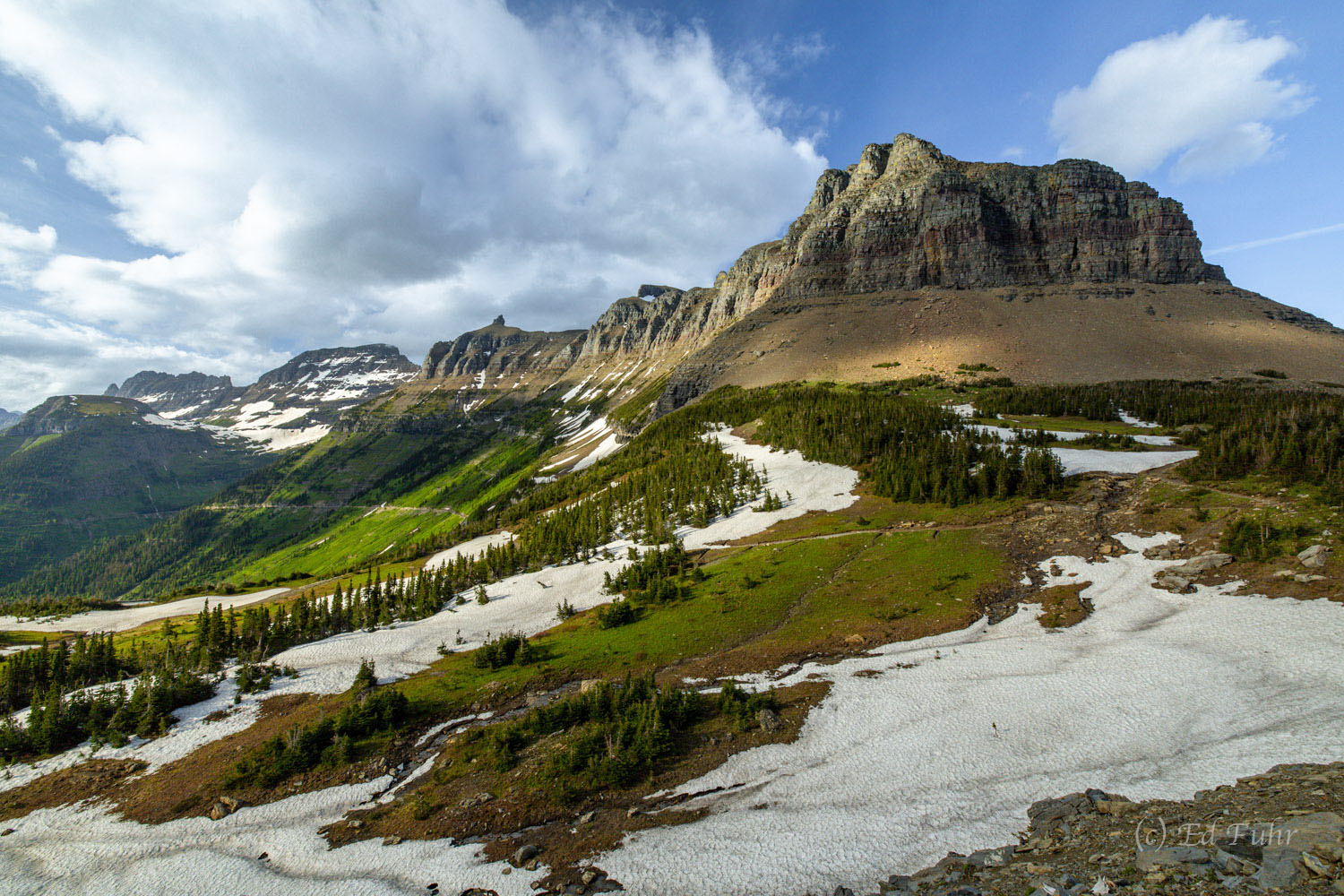 Even in mid July, the Garden Wall above the Goin to Sun Road is guarded by heavy snow.