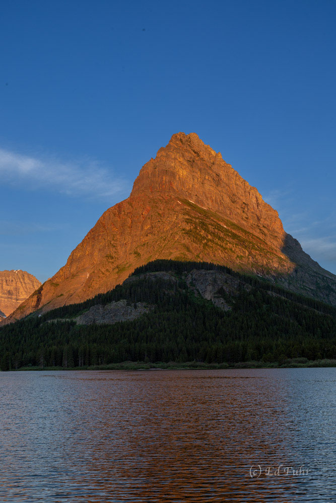 Grinnell Point is the exclamation point above Swiftcurrent Lake on a brilliant sunrise.