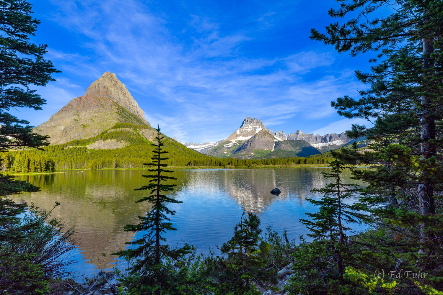 Mount Wilburn looms above Swiftcurrent Lake as viewed from the trail enroute to Josephine Lake.