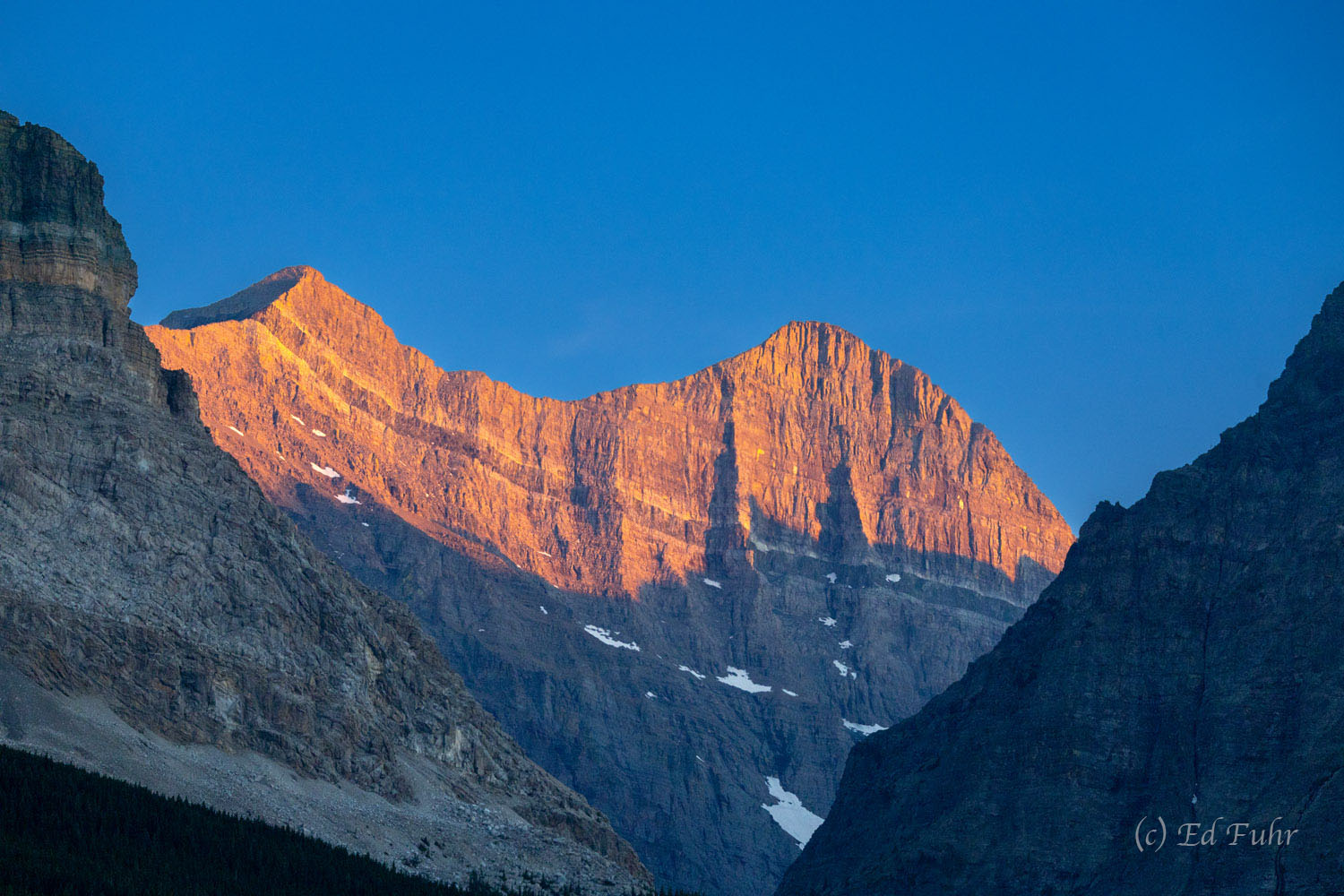 The late light of day warms the mountain range east of Many Glacier.