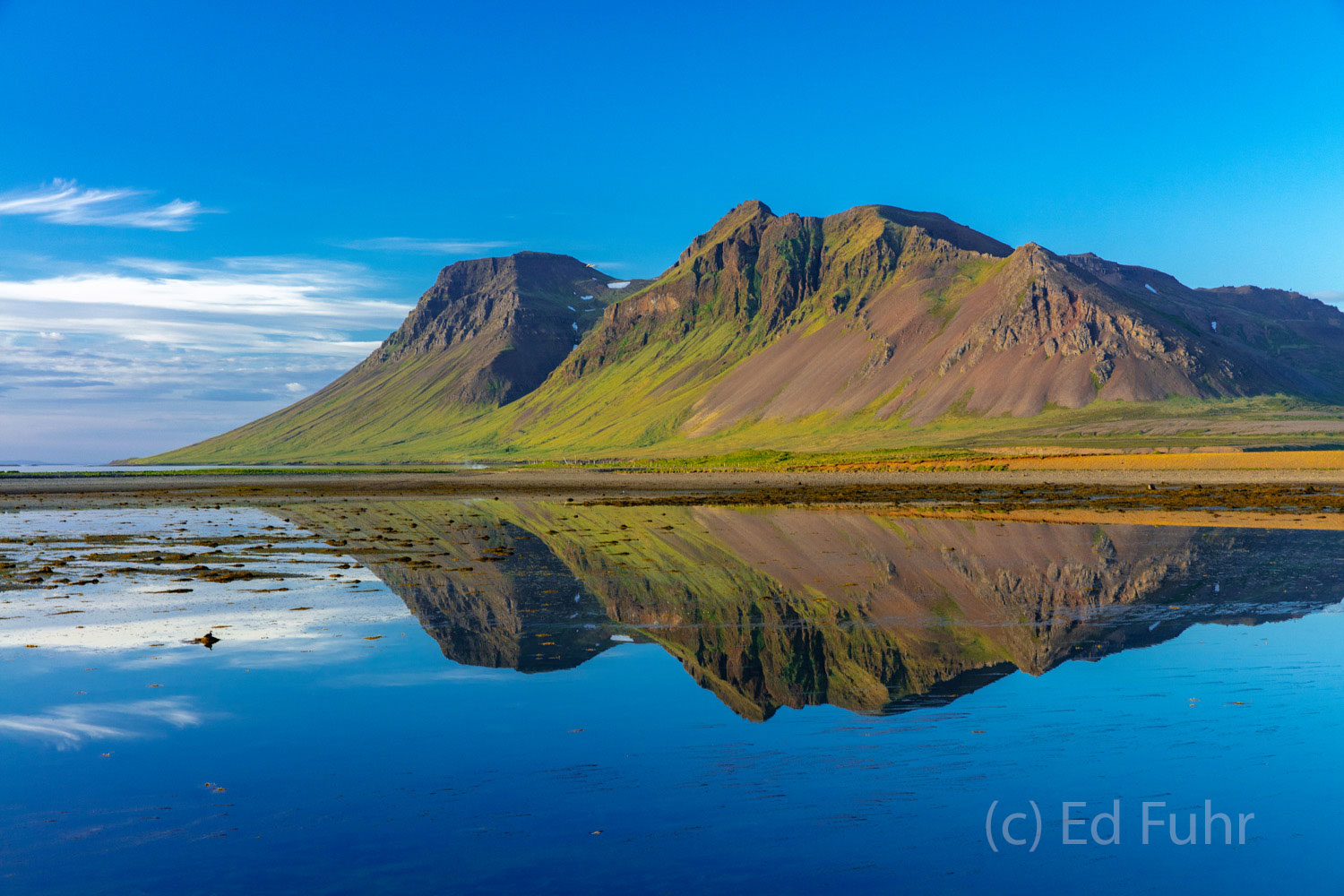 Mount Bjarnahafnarfjall In the late light of day, this small mountain reflects in the nearby bay.