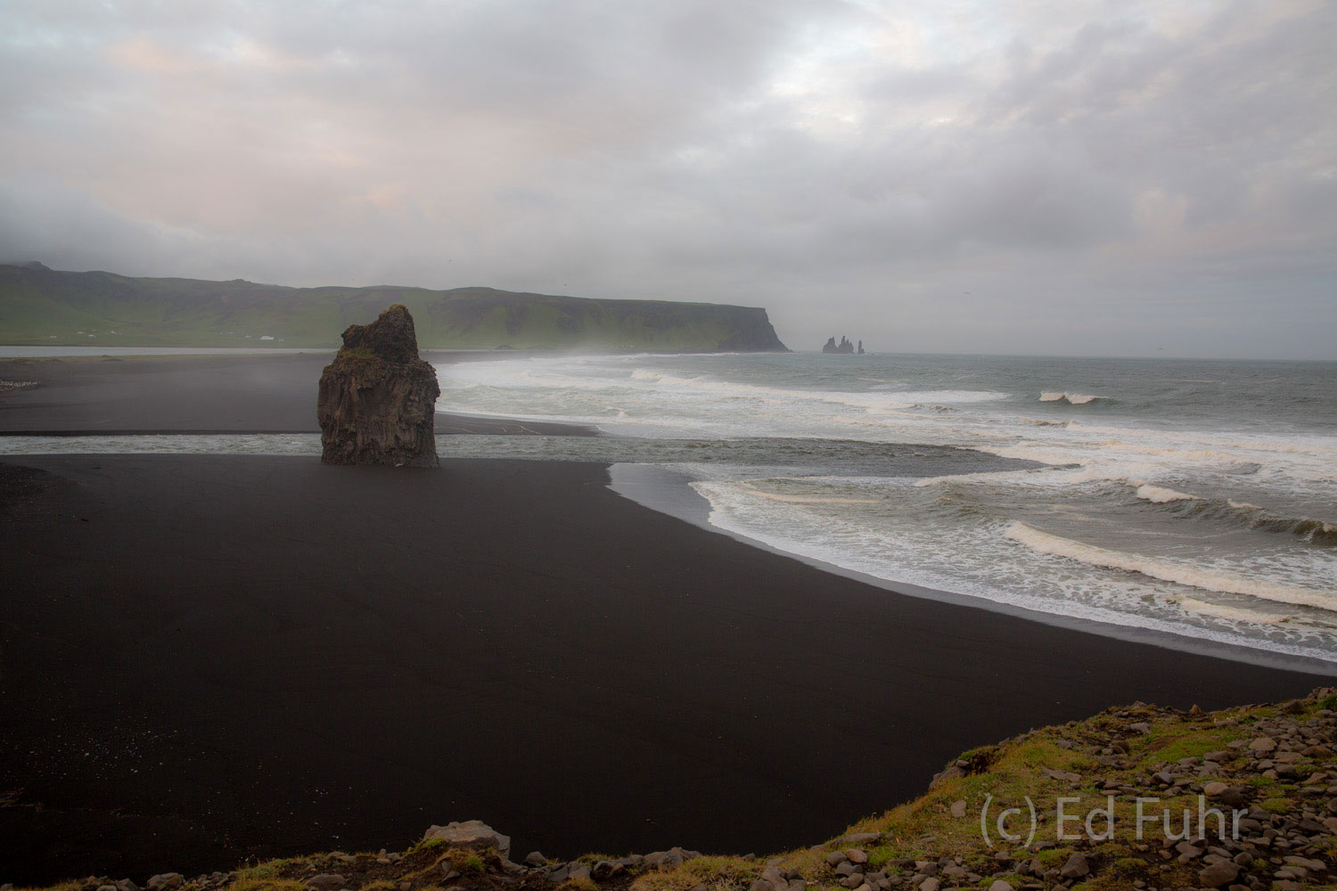 From the cliffs at Cape Dyrholaev stretch miles of black sand beaches.