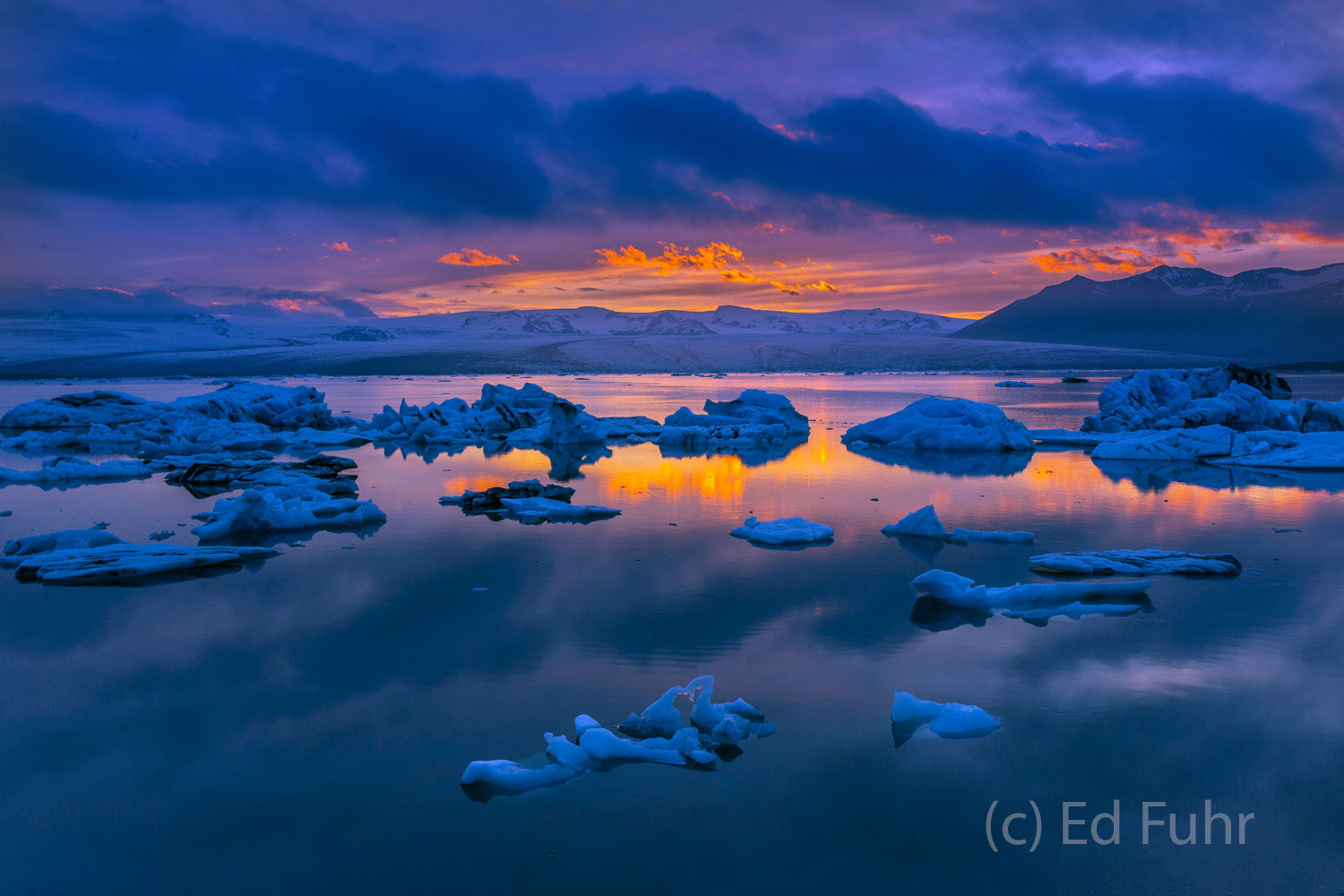 Jokulsarlon Serenity Beyond Jokulsarlon lagoon rises the glacier-covered mountains from which these icebergs have come. It is well past midnight...