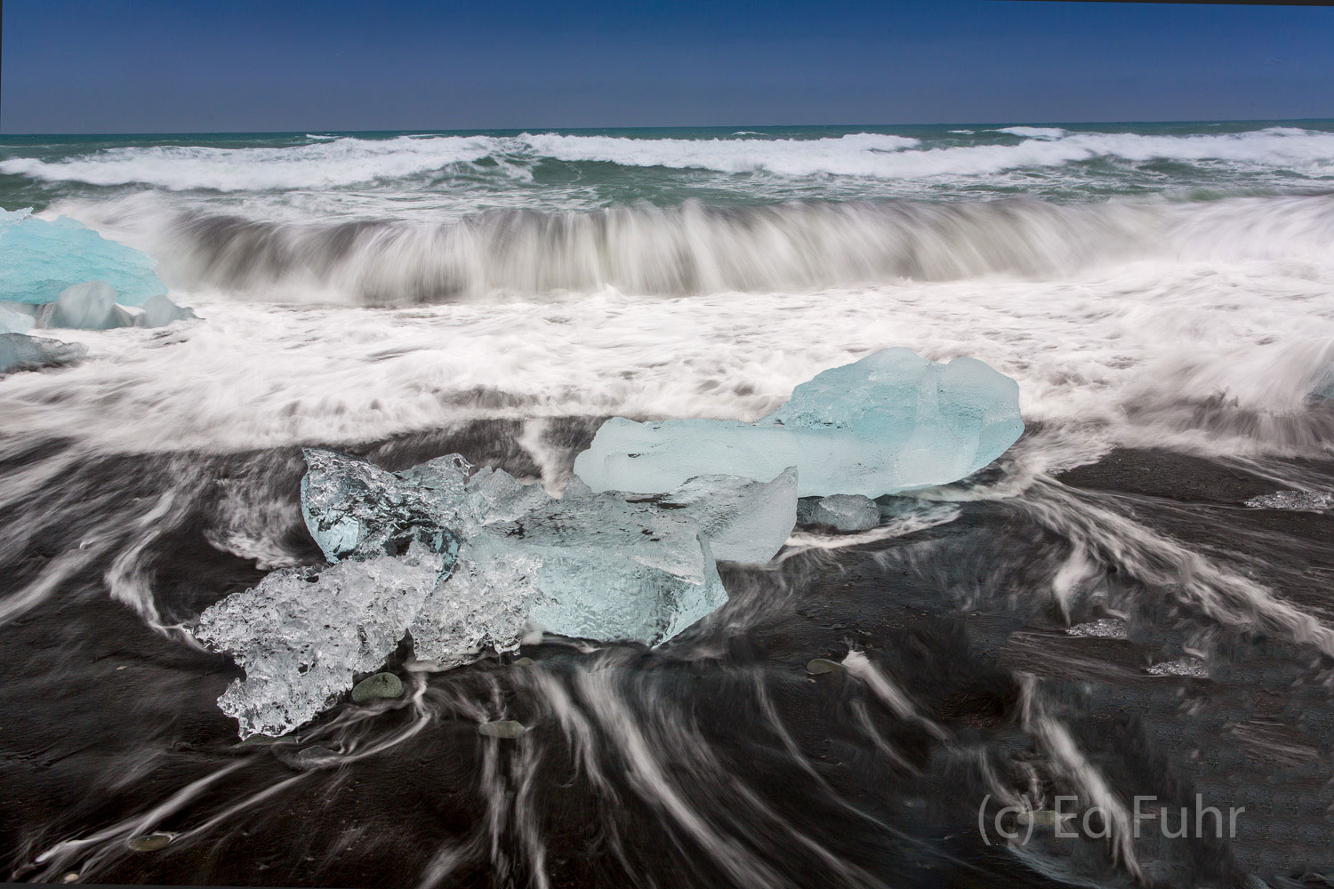 Shrinking Diamonds Waves of ocean water flow to and from across the shrinking diamonds on this deserted beach.