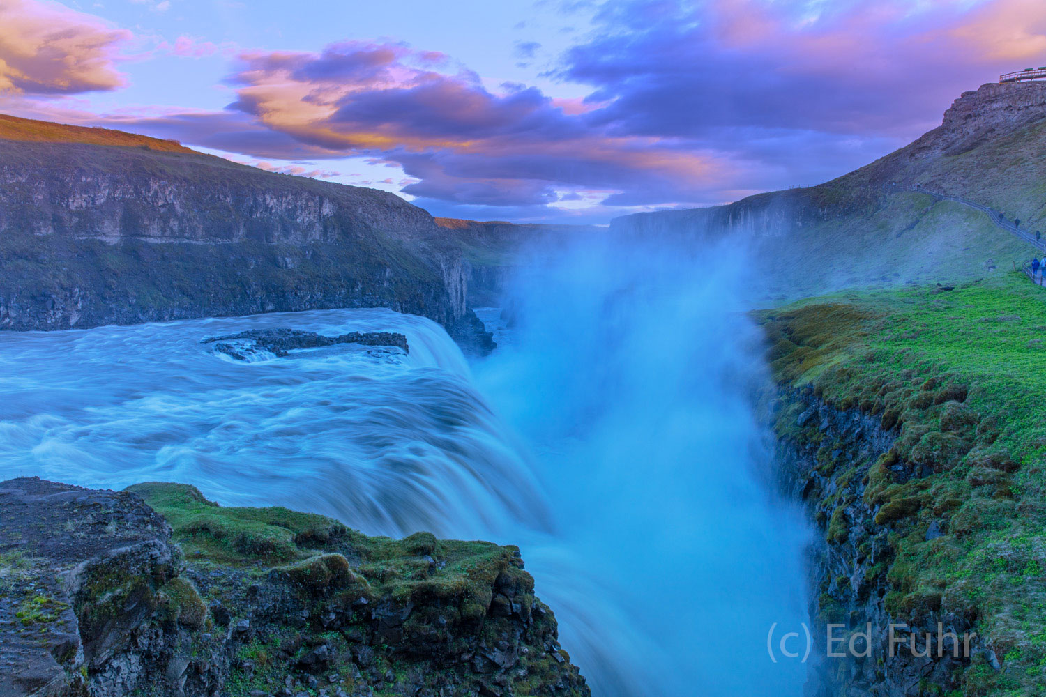 As the waters roar at Gullfoss, sunset colors the skies above.