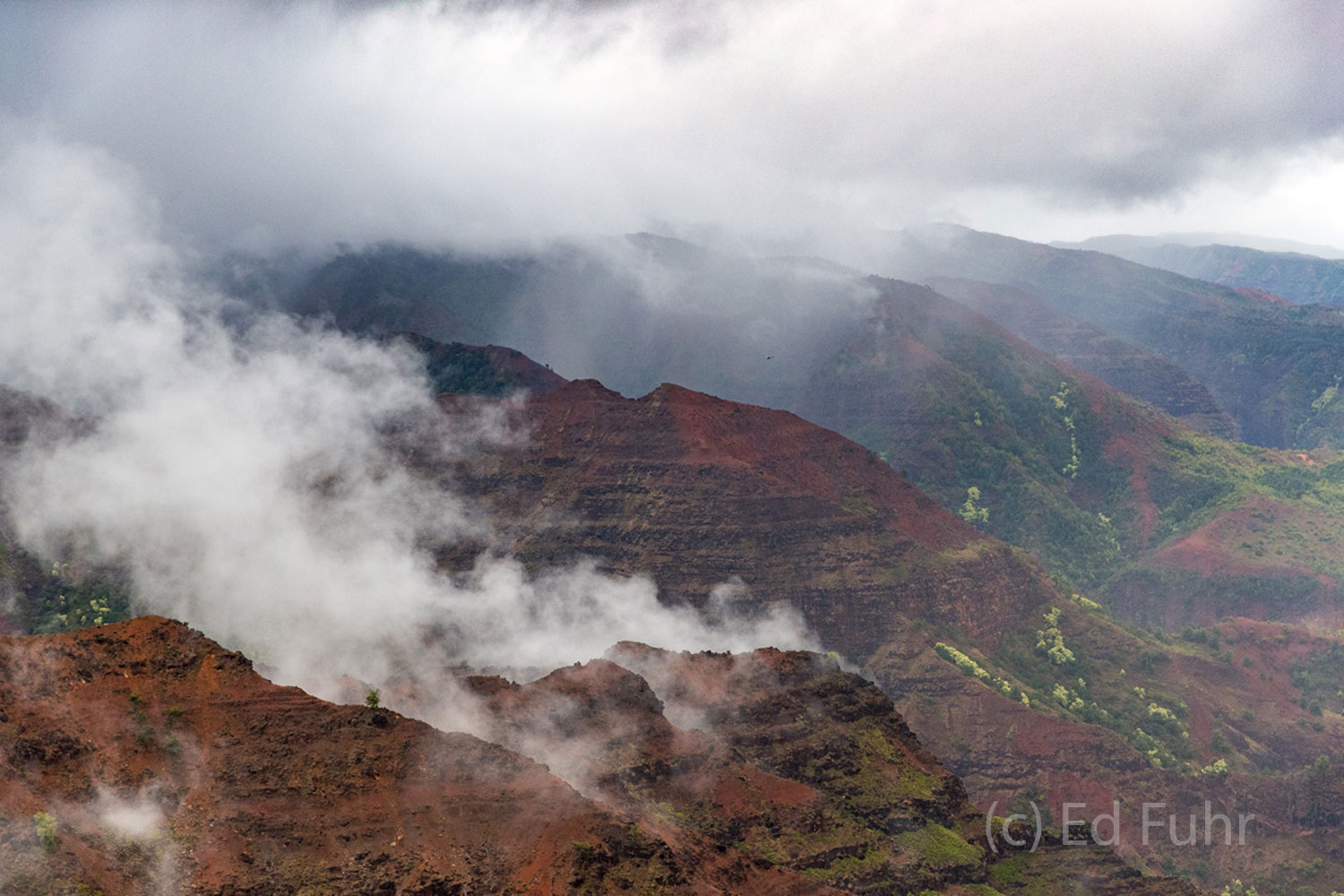 A passing storm clears the peaks above Waimea Canyon.
