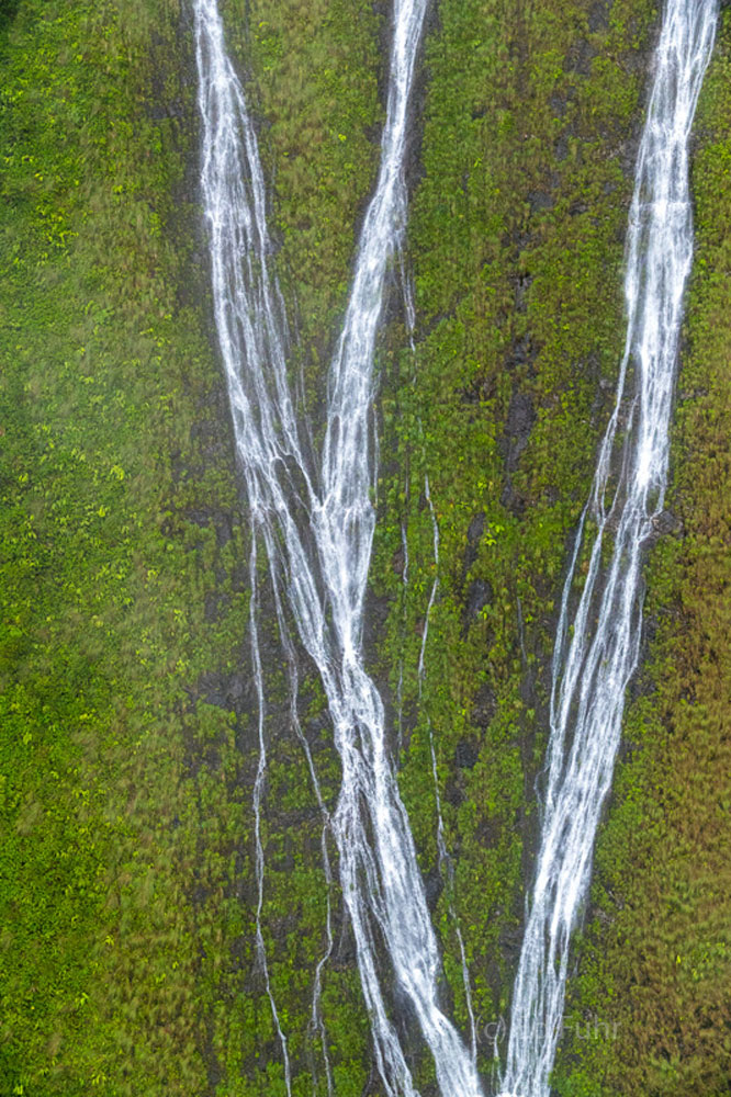 A two hour flight through and between Kauai's rugged mountains after heavy rains allows countless sights of temporary waterfalls...