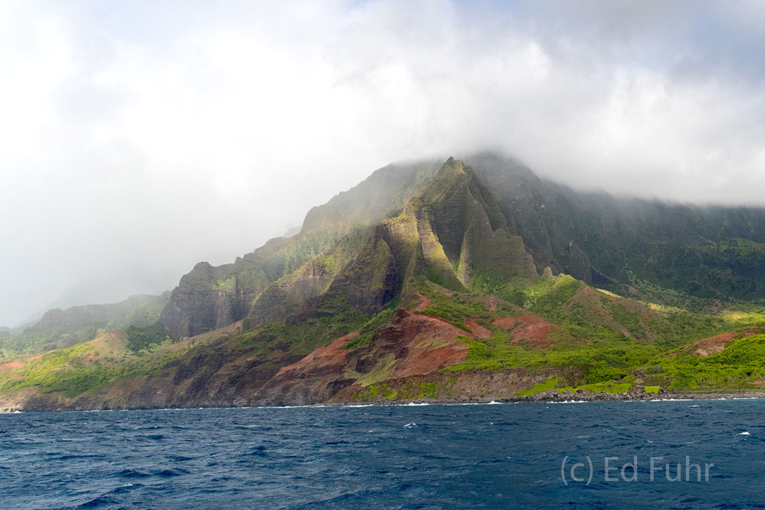 Clouds stream over the Na Pali coast's rugged mountains.
