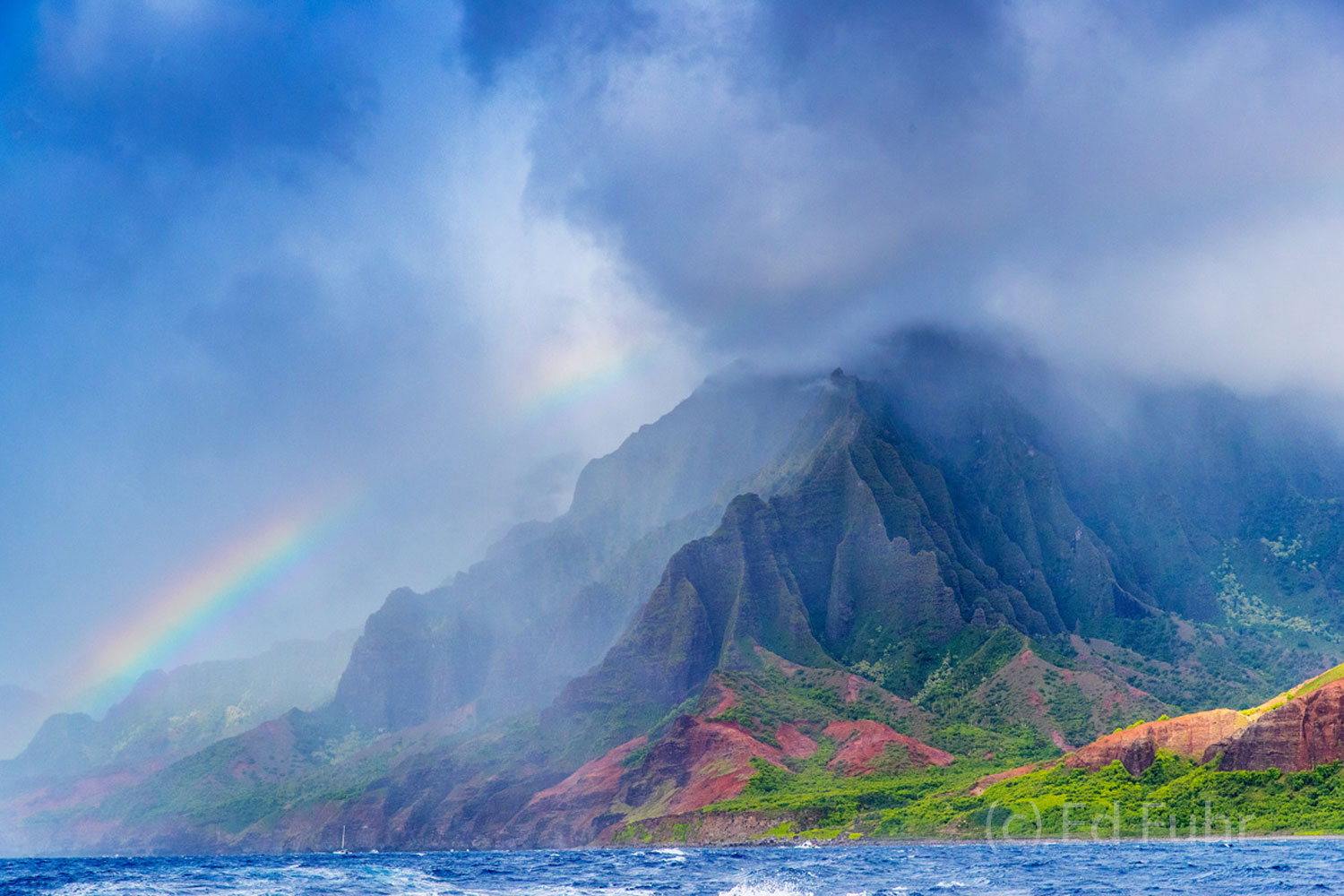 A storm moves over the Na Pali coastline with a rainbow reminder of eternal promises.