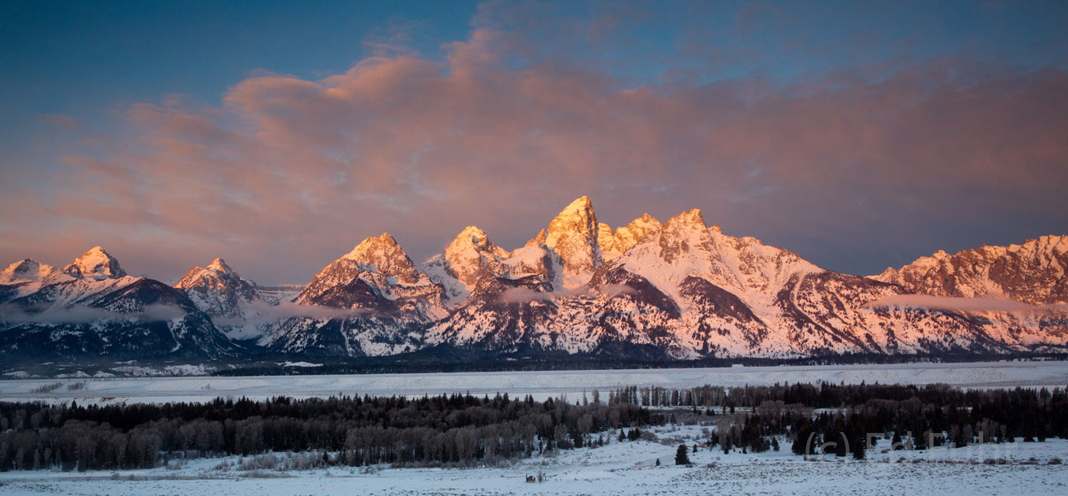 Sunrise glow lights the clouds above Schwabacher's Landing and the beaver ponds on this winter morning.
