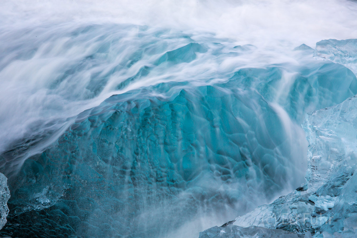 Water on Ice A soft waves cascades over this blue chunk of ice.