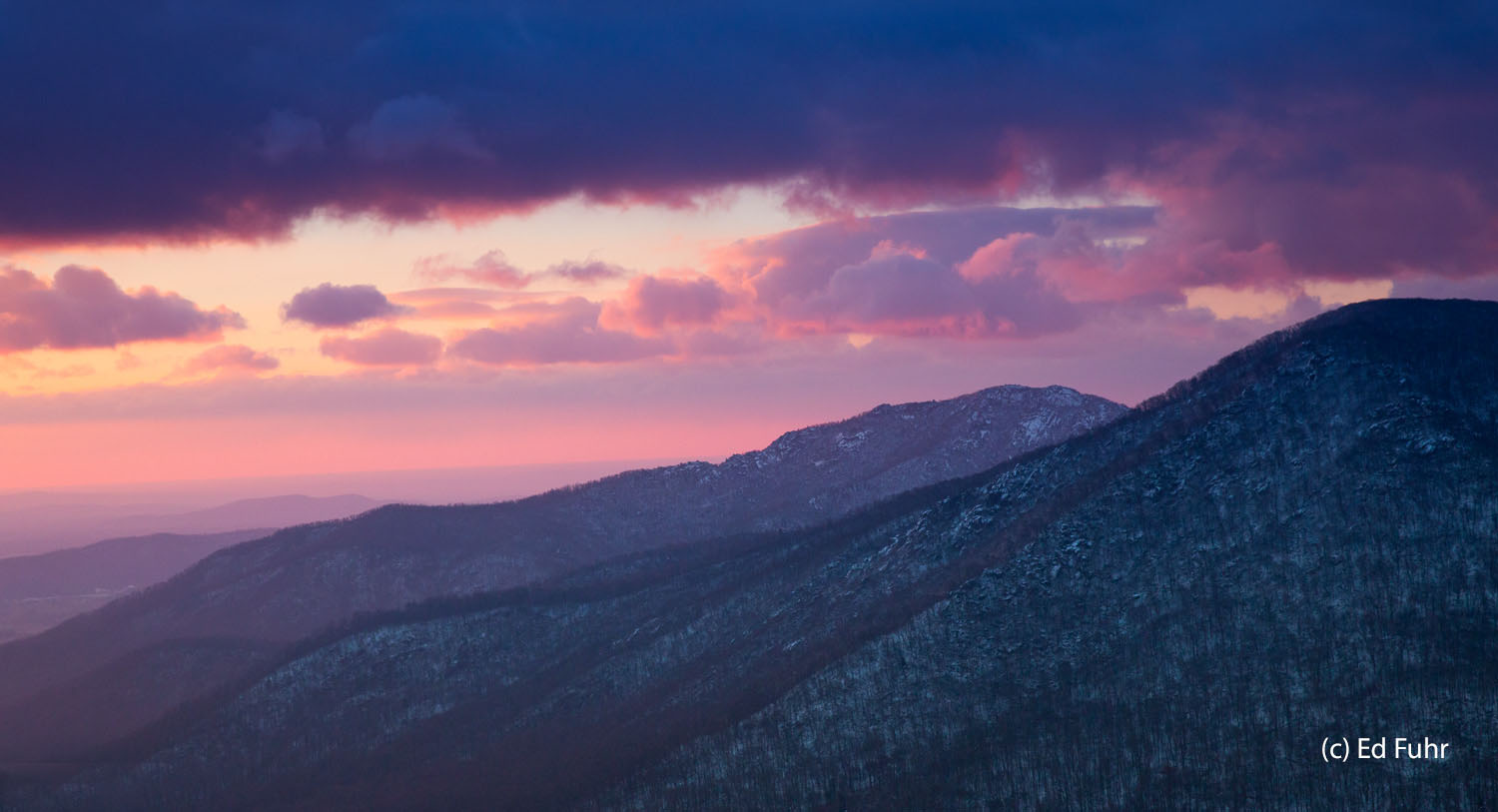 Old Rag Mountain beckons in the quiet of dawn after a day of heavy snow.  The storm is clearing and the mountains rise below...