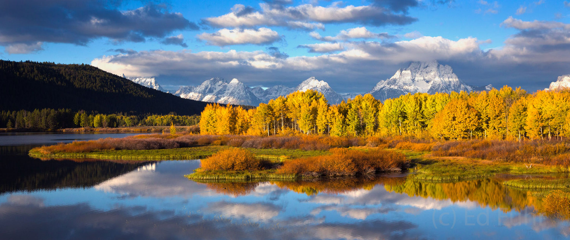 A panorama of Oxbow Bend at peak fall foliage following a surprise snow on the mountains.