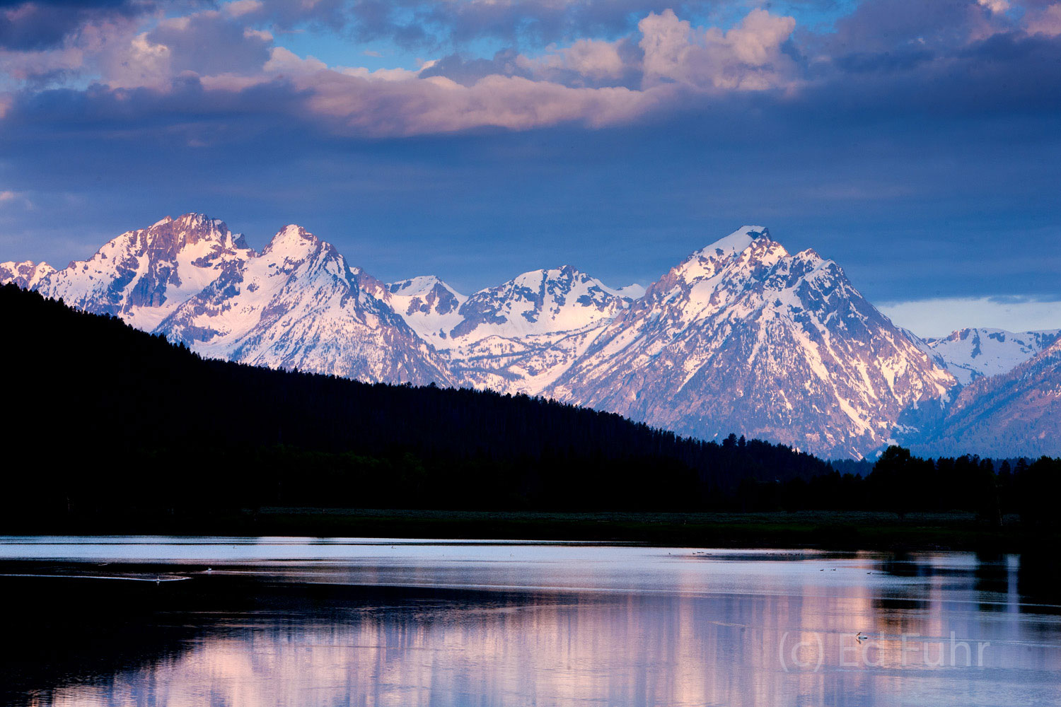 Snow-capped peaks of the Teton mountain range rise above the slopes of Signal Mountain.