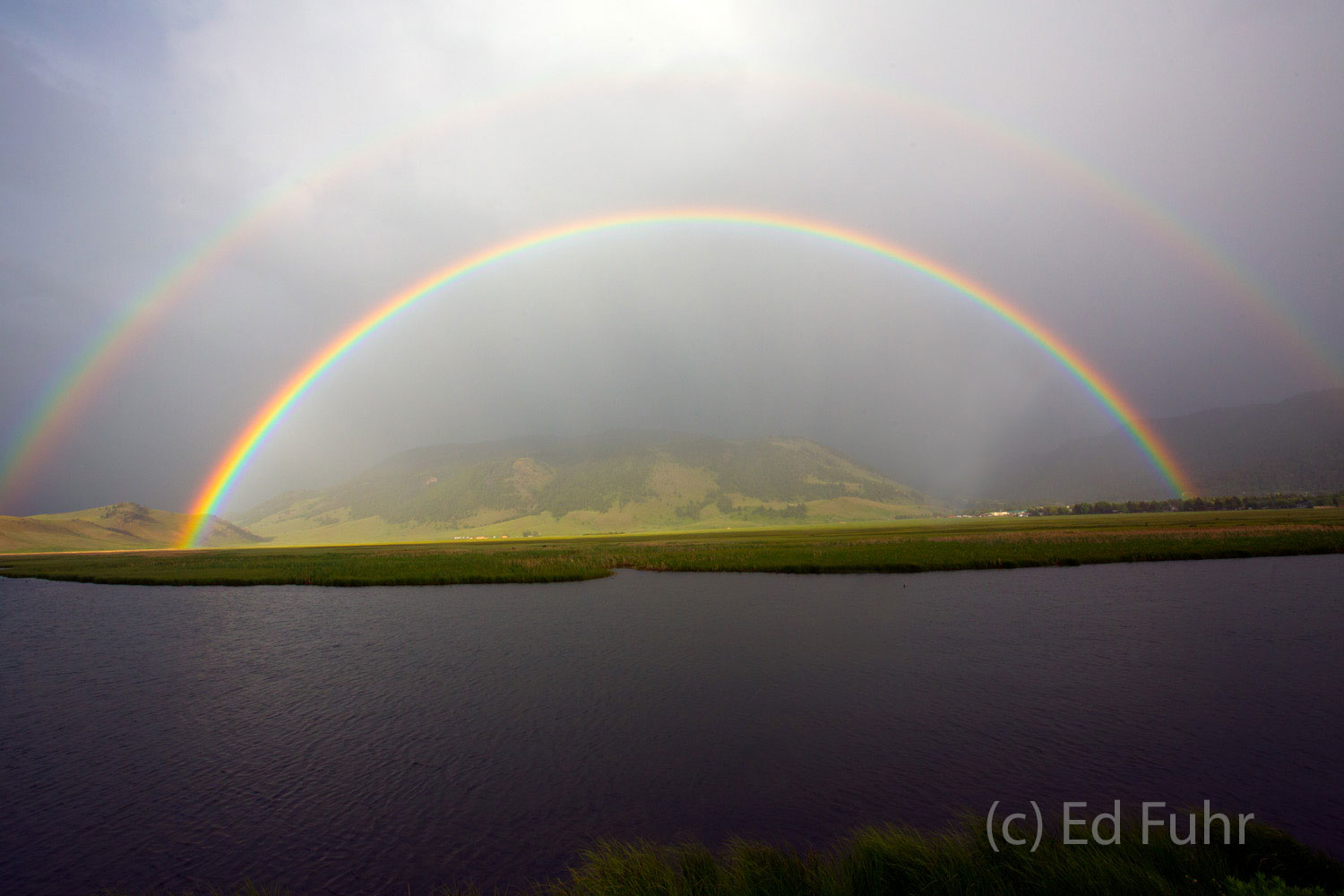 As a summer storm passes, a double rainbow emerges with the promise of better tomorrows.