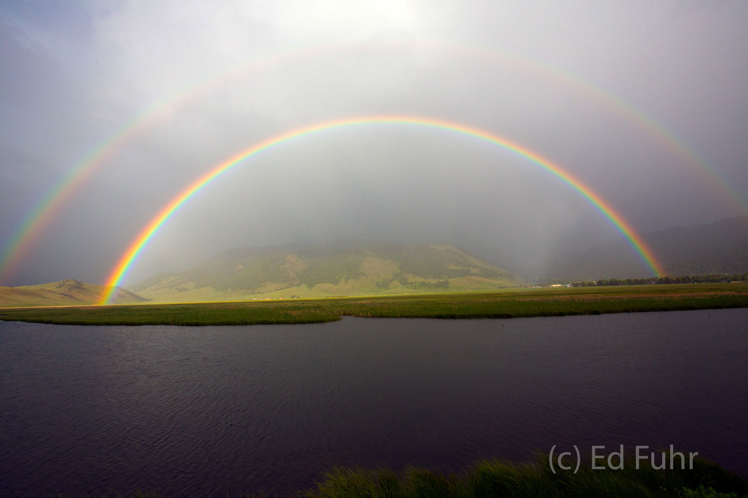 Double Rainbow Promise As a summer storm passes, a double rainbow emerges with the promise of better tomorrows.