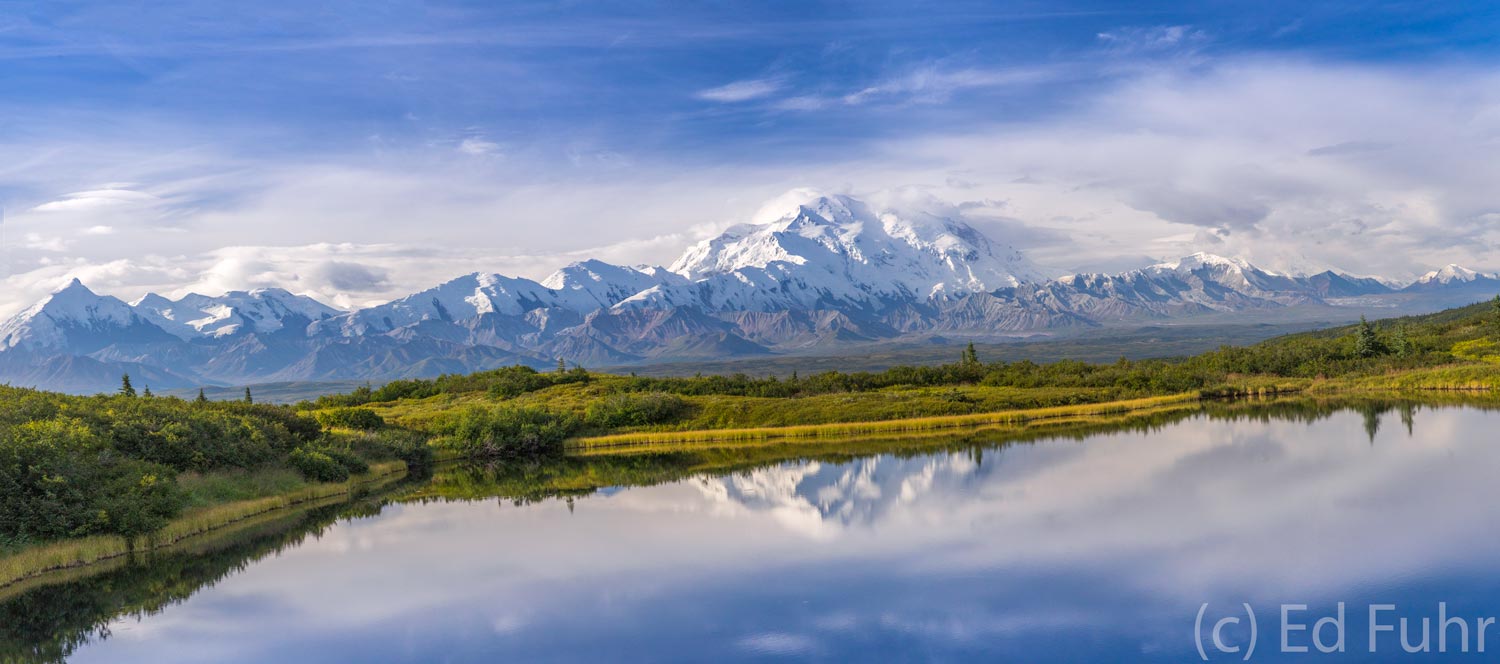 Reflection Pond Panorama On a rare clear midday, snow-capped Mount Denali rises above aptly named Reflection Pond. The sheer magnitude of the...