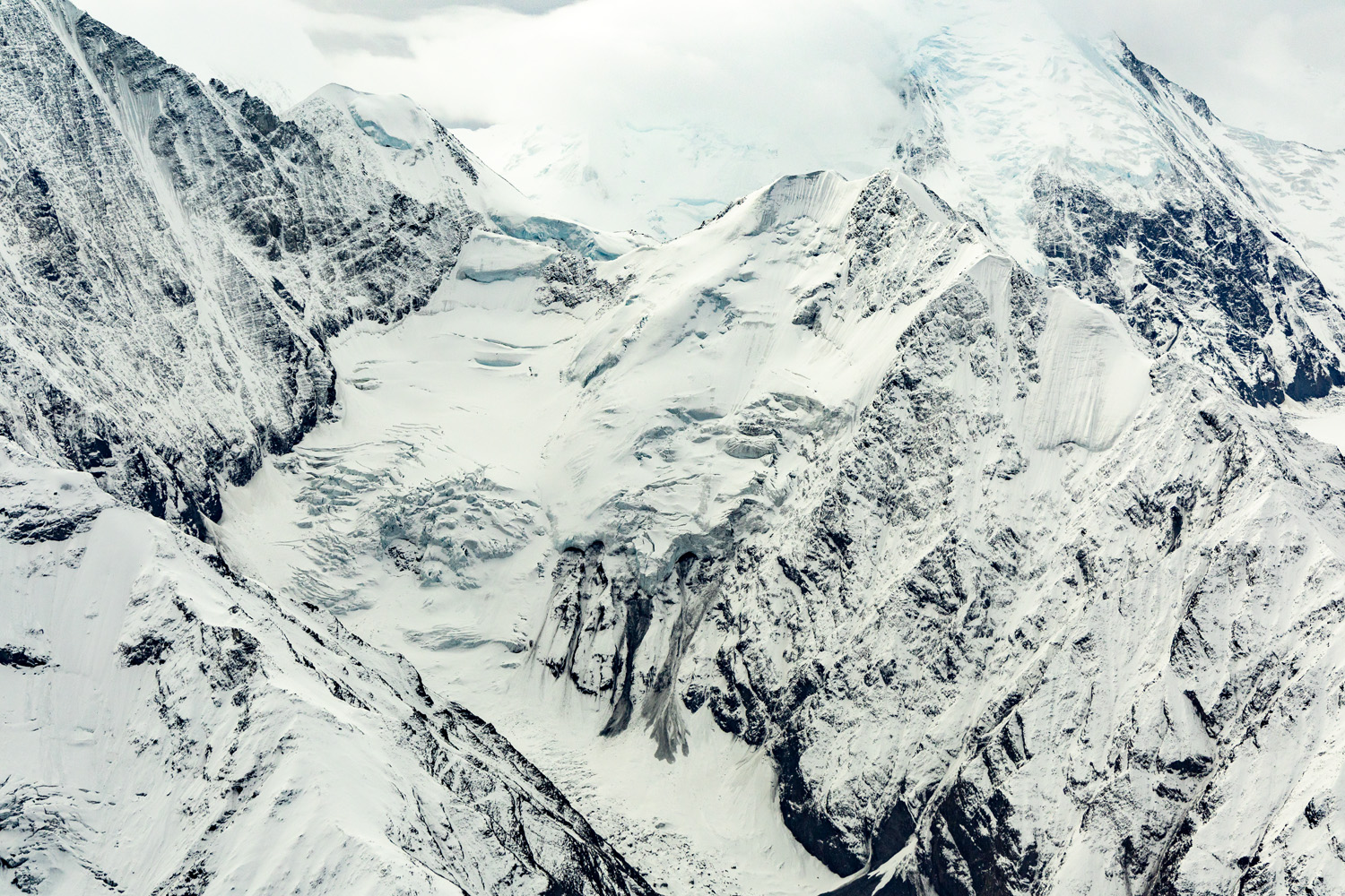 Denali Aerial From Denali's lofty peaks flow massive sheets of ice and glaciers that slowly, inexorably grind everything in their path, carving...