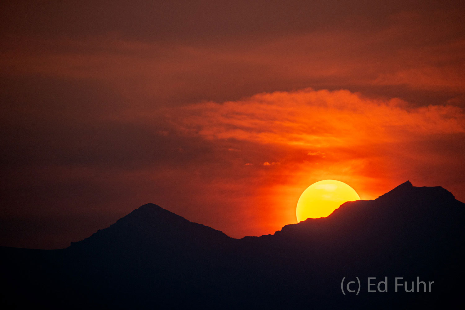 Sunset Through the Smoke The sun sets over Rendezvous mountain in the Teton Range, through the smoke and haze from California's wildfires