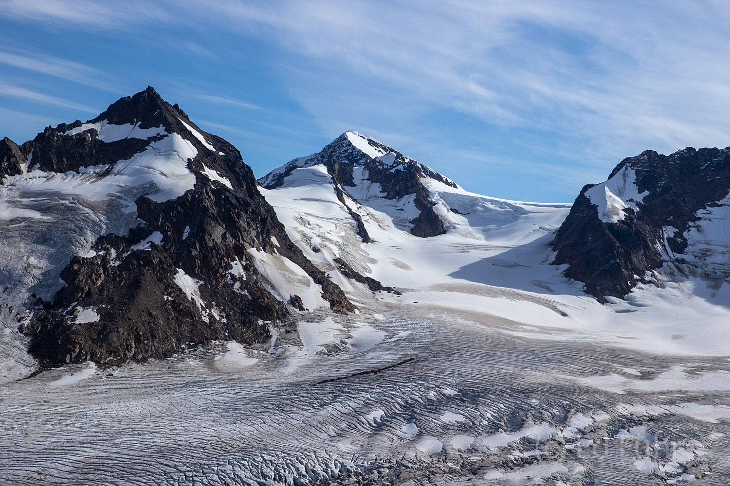 Sweeping down from mountains high, massive glaciers stretch as far as the eye can see.