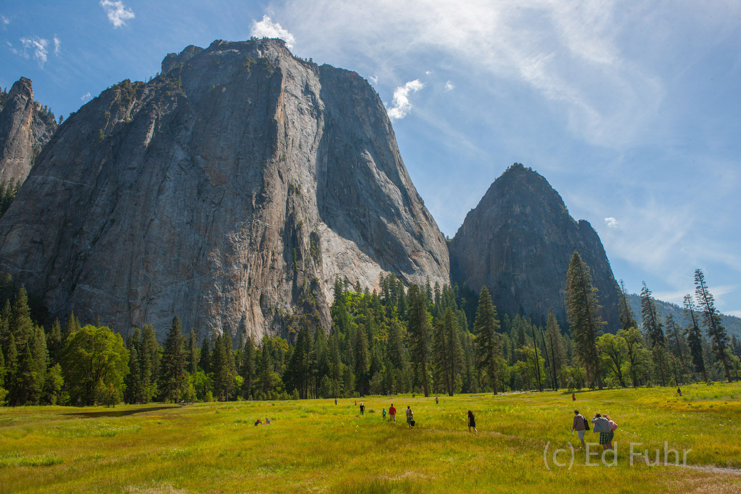 Hikers cross the valley below Cathedral Rock