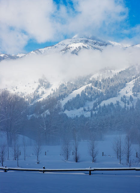 The Teton range rises above the fog and clearing clouds this cold winter morning.&nbsp;