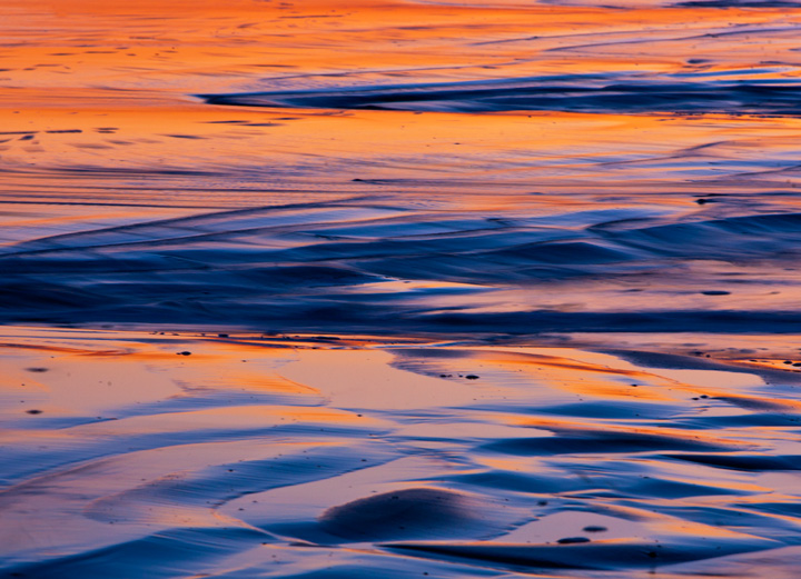 After sunset, the ocean glows with the reflected reflection of a clouds on the western horizon.&nbsp;